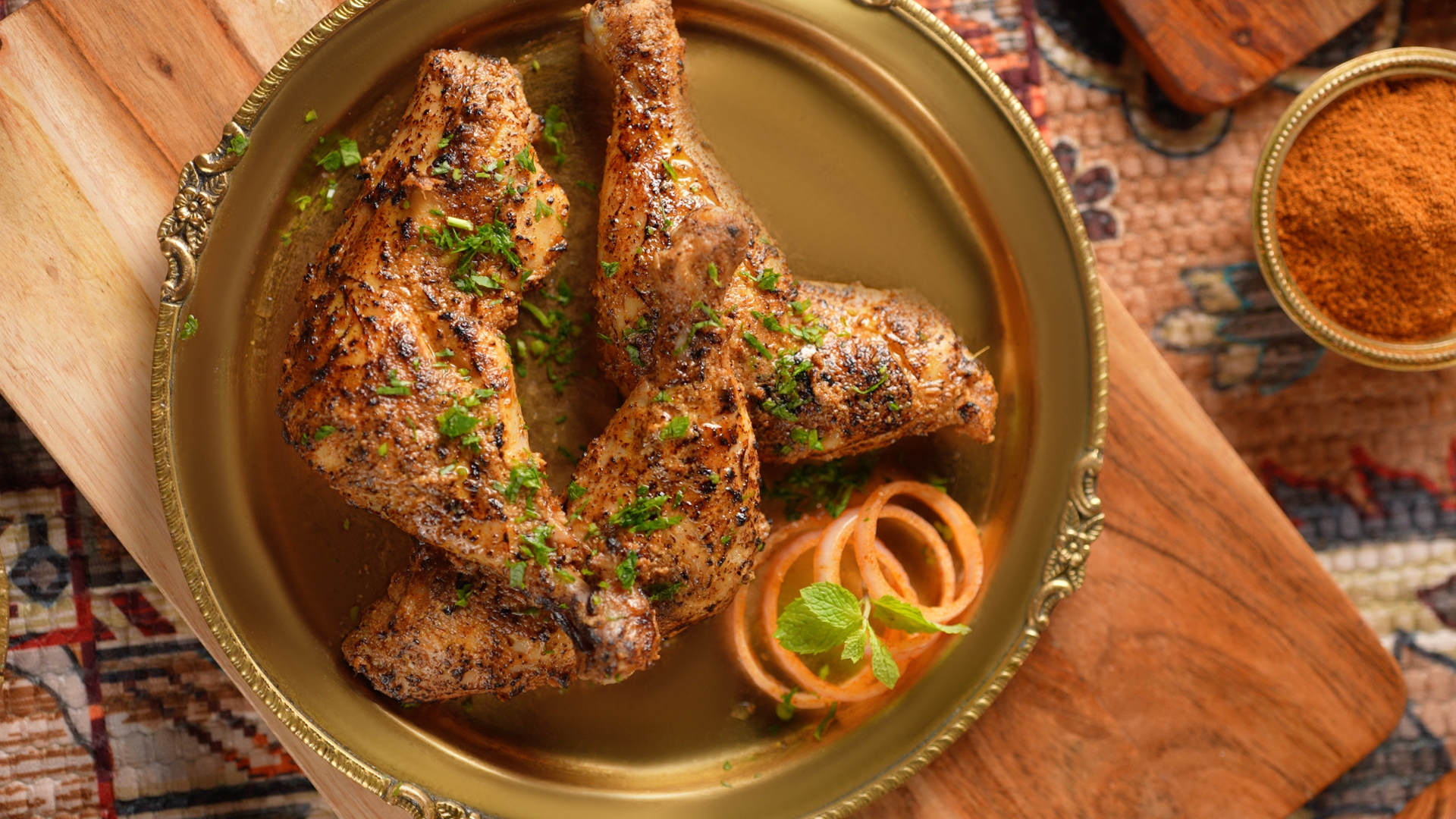Authentic Tandoori Chicken platter seasoned with premium Indian BBQ spices and rubs from the Mrs. Balbir Singh heritage collection.